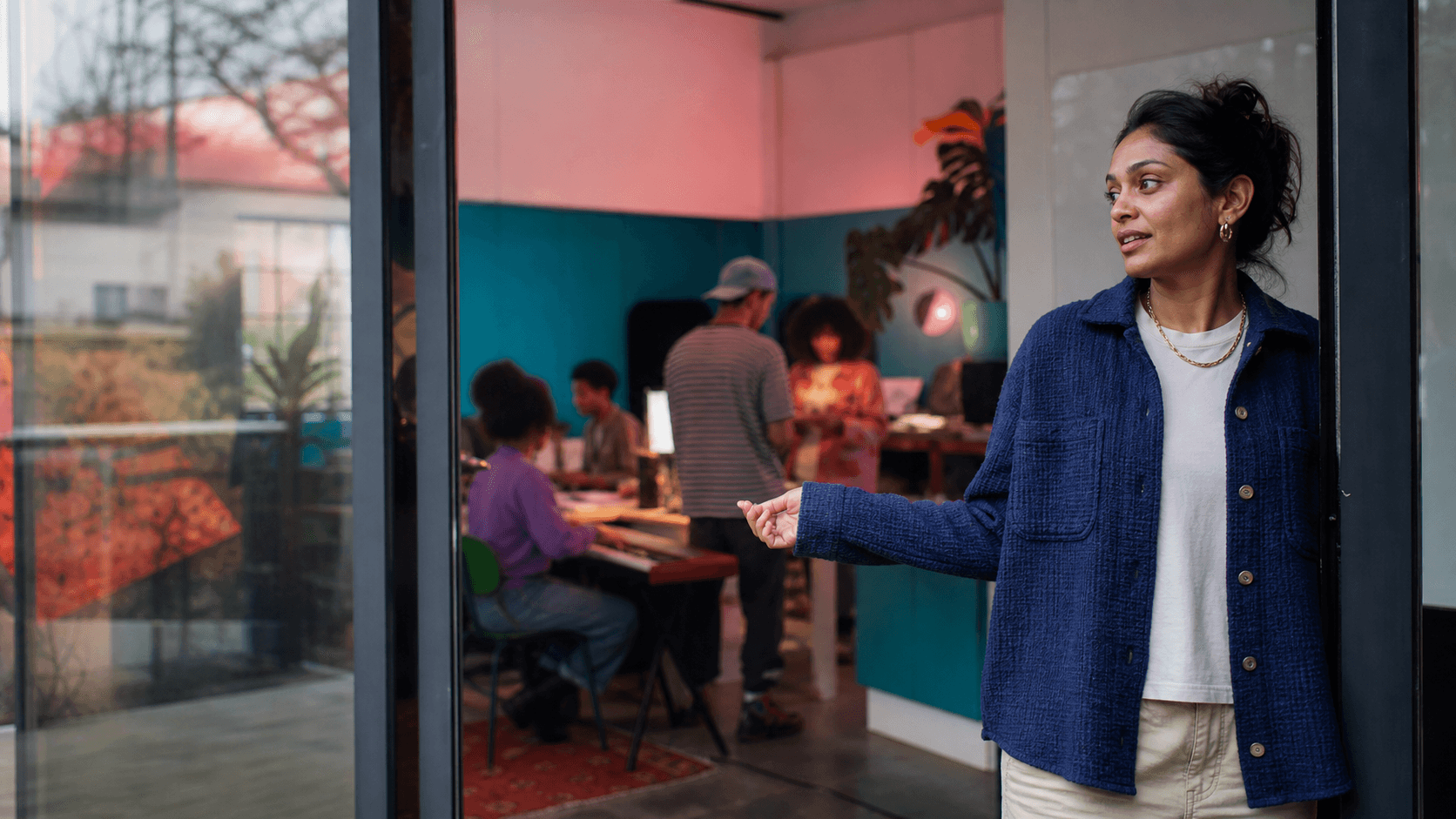 A host welcoming someone into a community arts studio