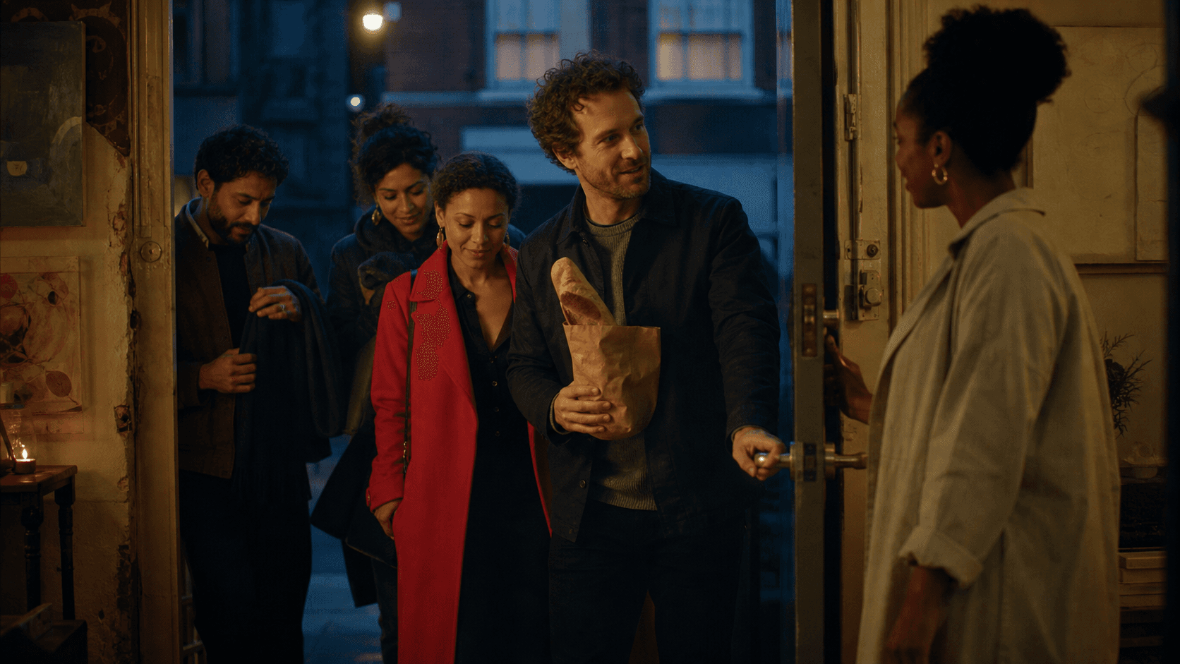 Friends arriving for a community supper at an arts studio