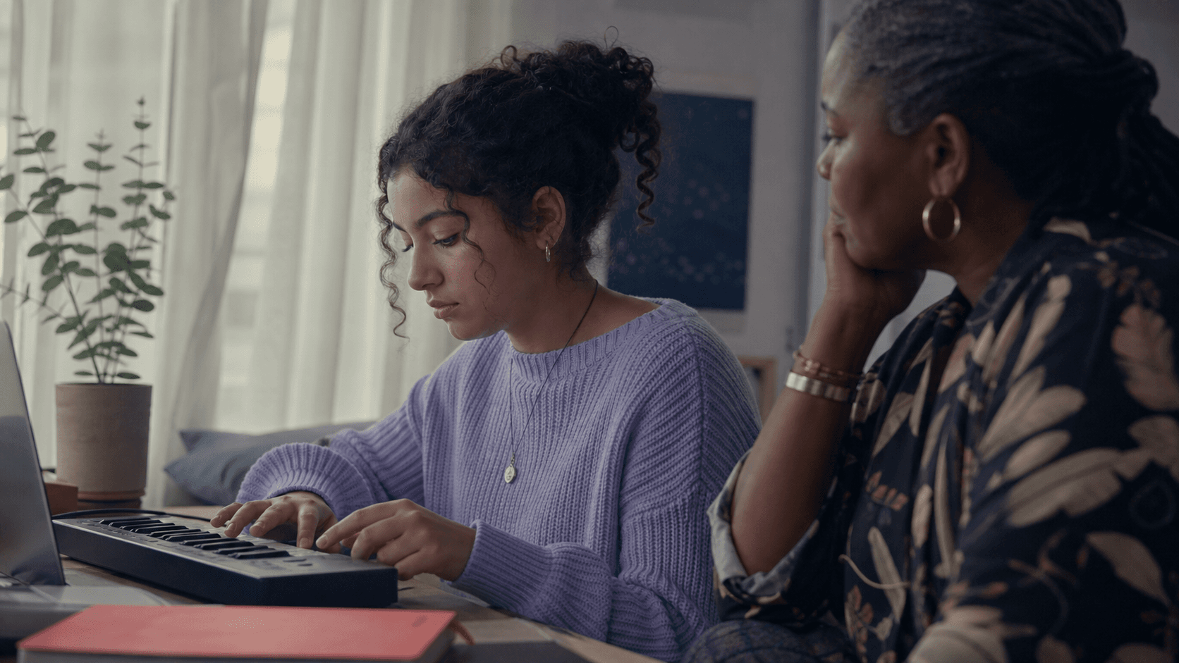 A student developing a music project with support from a mentor